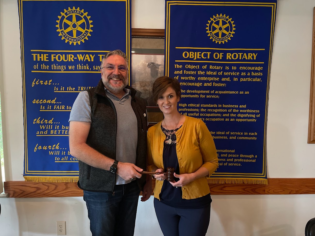 Immediate Past President Nicole Johnson passes the gavel to incoming President Rob Moore.